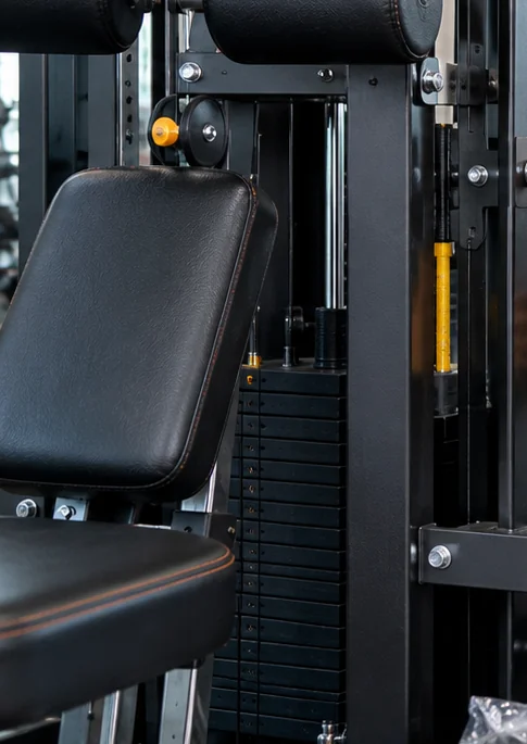 Close view of an unloaded strength-machine frame with mounting points and weight-stack hardware