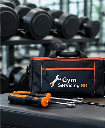 A branded Gym Servicing BD tool bag and hand tools placed beside gym equipment