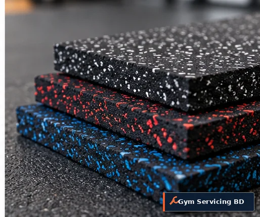 Stack of three speckled rubber gym mat samples in black, red and blue