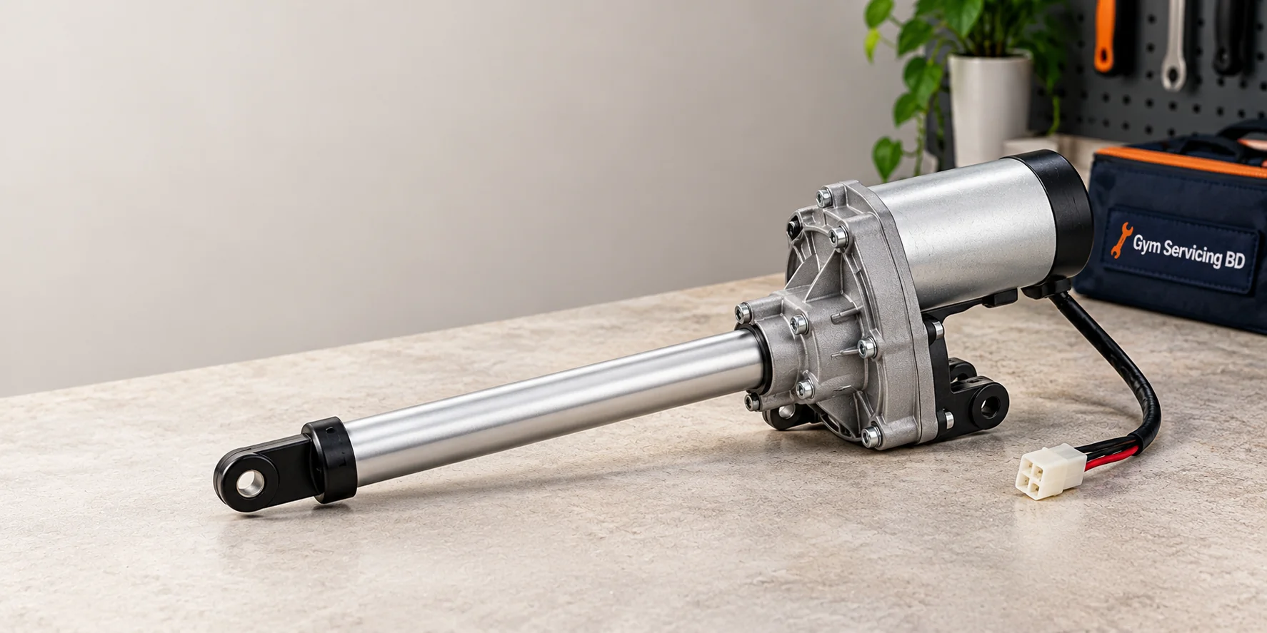 Illustrative treadmill incline lift motor with an extended rod and cable connector on a workbench beside a Gym Servicing BD tool bag